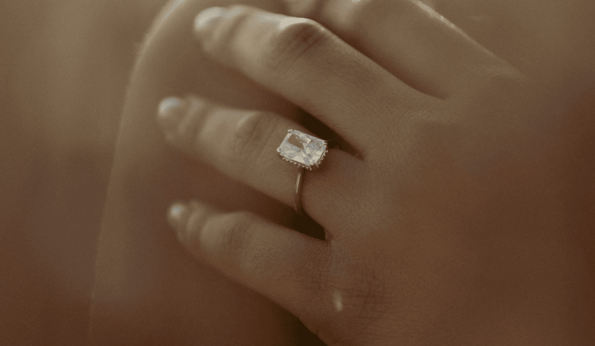 Hand wearing a For Your Eternity ring