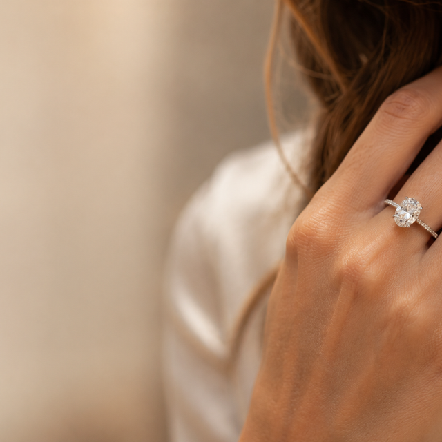 A solitaire diamond engagement ring worn on a hand