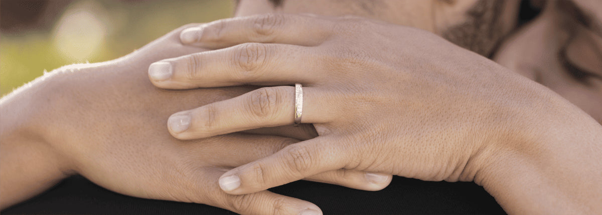 Couple wearing a pair of wedding rings