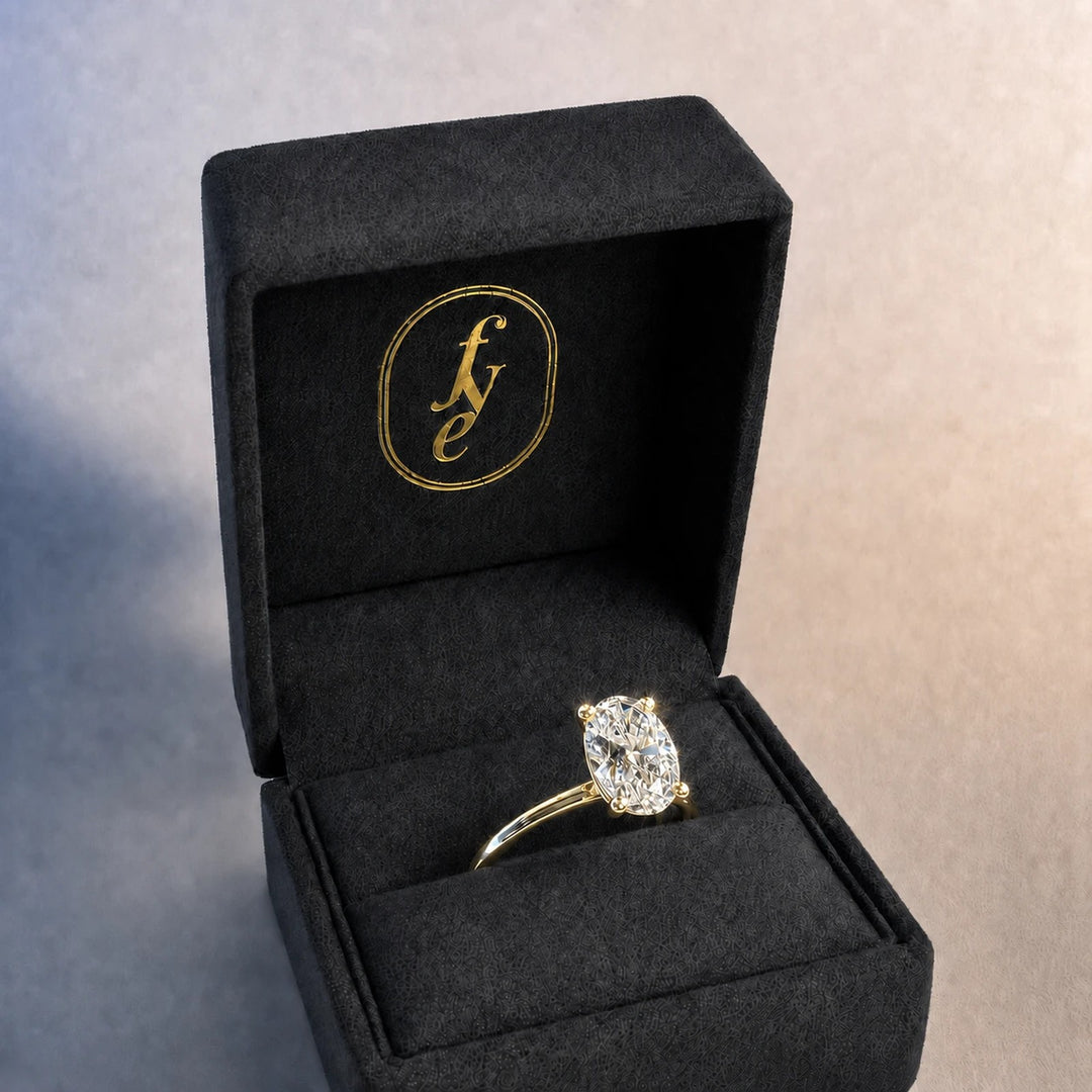 Oval diamond solitaire engagement ring in 9ct yellow gold, presented in a For Your Eternity ring box