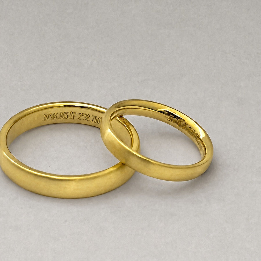 A pair of custom curved 18ct yellow gold wedding rings with a matt finish