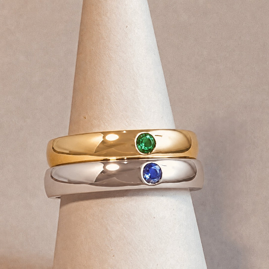 Emerald and tanzanite set wedding rings in 18ct yellow and white gold