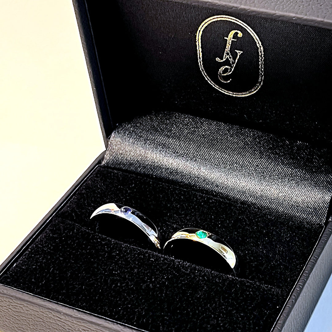 Emerald and tanzanite wedding rings in a For Your Eternity gift box