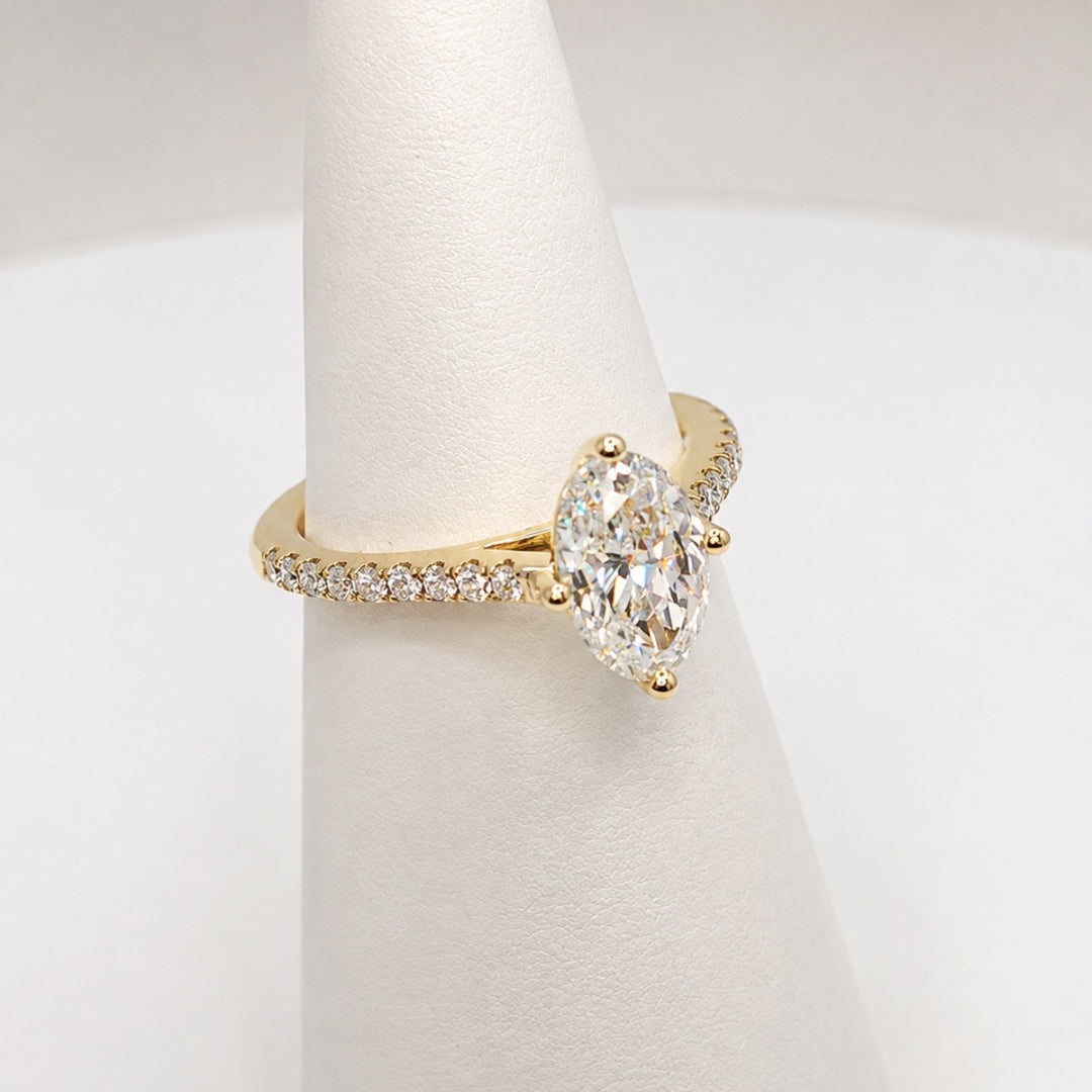 Oval diamond engagement ring in 18ct yellow gold shown on a ring cone