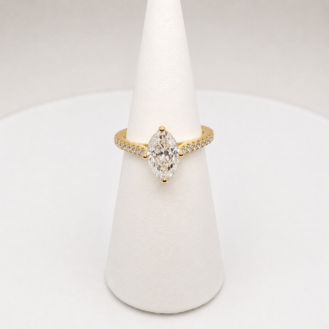 Oval diamond solitaire in 18ct yellow gold with diamond set shoulders