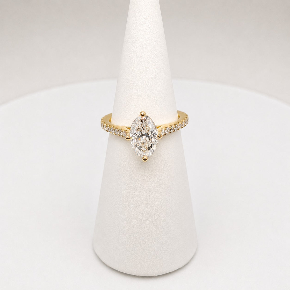 Oval diamond solitaire in 18ct yellow gold with diamond set shoulders