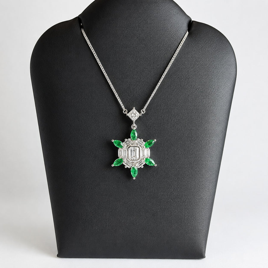 Platinum diamond and emerald pendant shown on its fixed platinum chain