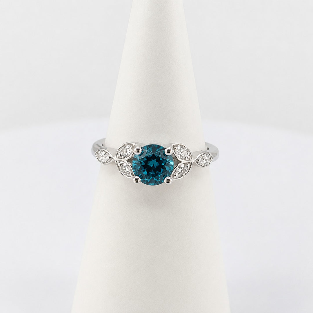 Round brilliant teal sapphire engagement ring in platinum