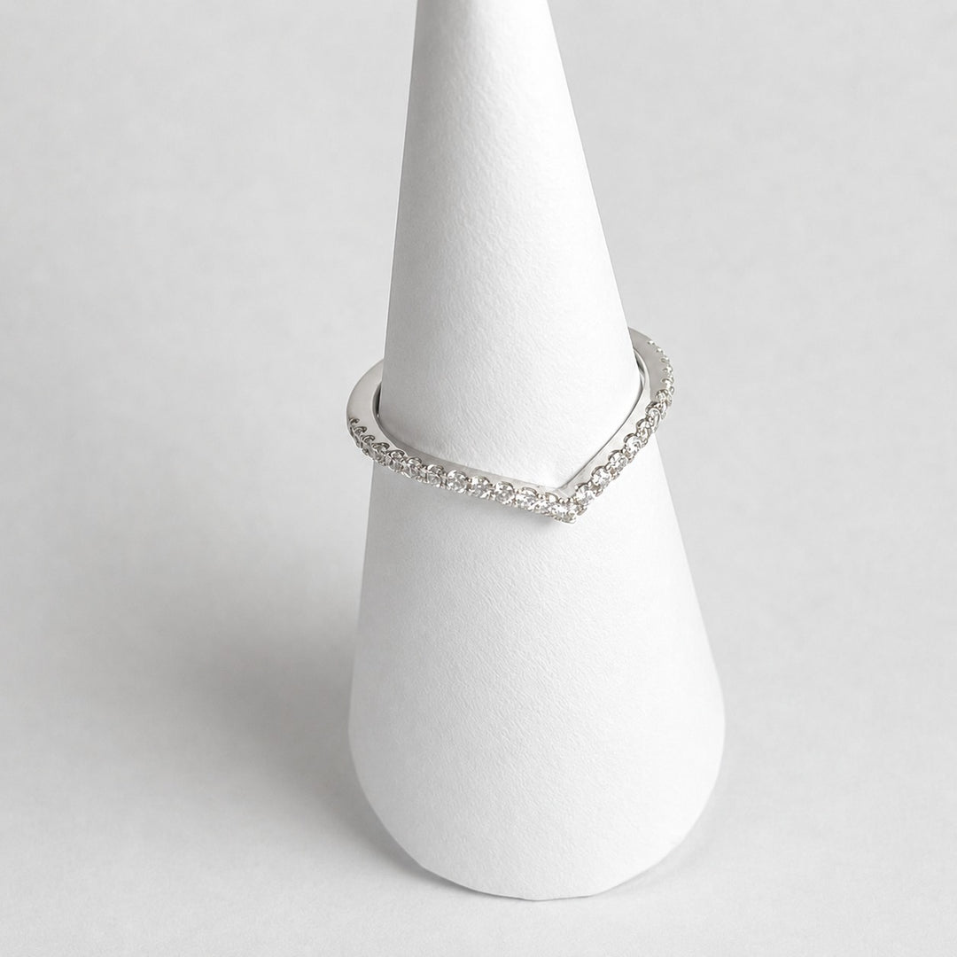 Shaped platinum wedding ring with a chevron curve and micro-claw set diamonds