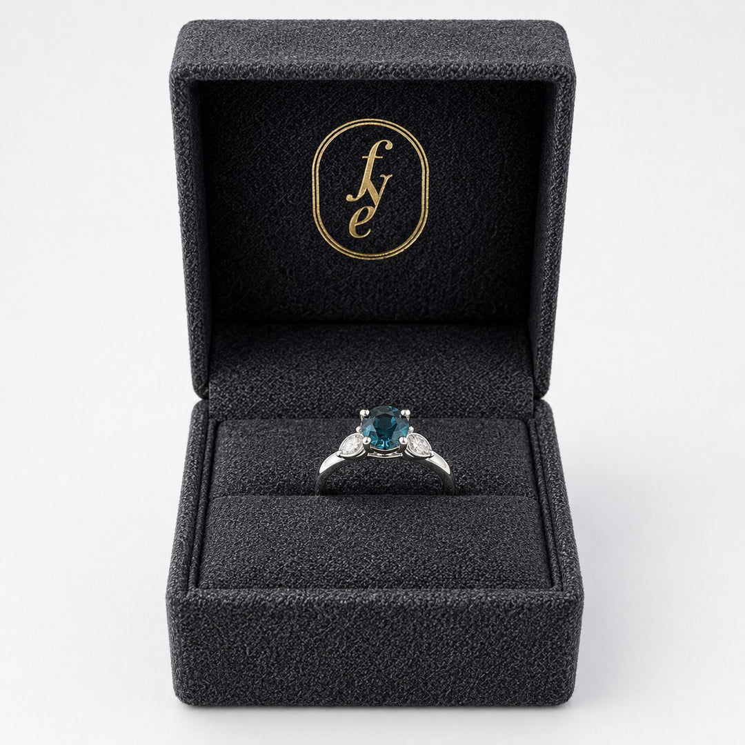 Teal sapphire platinum engagement ring in a For Your Eternity gift box